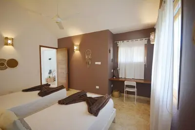 a hotel room with two beds and a desk at House with pool 300 m from Las Ballenas beach in Las Terrenas