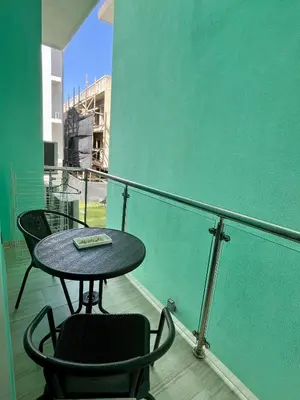 a table and two chairs sitting on a balcony at Maple Beach, apartamento en Punta Cana in Punta Cana
