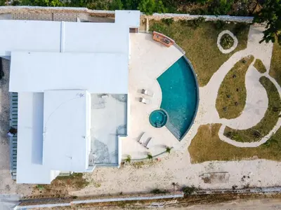 an aerial view of a house with a swimming pool at Luxury Oceanfront Villa with Heated Pool, Jacuzzi, AC, BBQ, Starlink Wi-Fi, Chef's Kitchen, Staff Included, Mountain Views, Near El Quemaito, San Rafael, and Los Patos Beach in Santa Cruz de Barahona