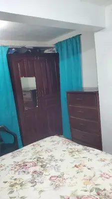 a bedroom with a bed and a dresser and a door at My hogar in Colorado