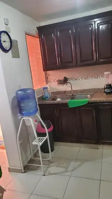 a kitchen with a sink and a blue bucket on a chair at My hogar in Colorado