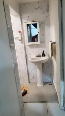 a white bathroom with a sink and a mirror at My hogar in Colorado