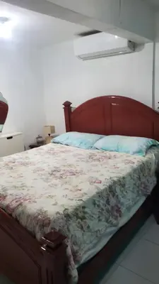 a bedroom with a bed with a floral blanket at My hogar in Colorado