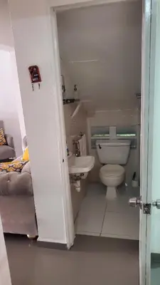 a small bathroom with a toilet and a sink at My hogar in Colorado