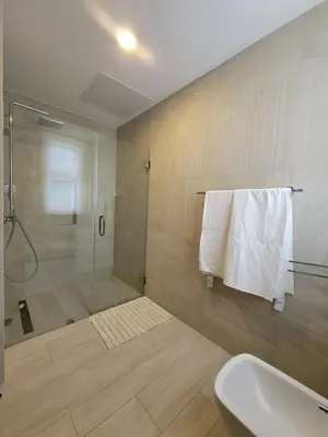 a bathroom with a shower and a sink at Modern 2BDR - Pool & Golf View in Punta Cana