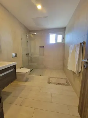 a bathroom with a toilet and a shower at Modern 2BDR - Pool & Golf View in Punta Cana