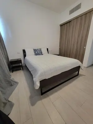 a bedroom with a bed and a wooden wall at Modern 2BDR - Pool & Golf View in Punta Cana