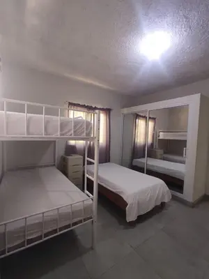 a bedroom with two bunk beds and a light at Hermosa Casa en Juana Vicenta Samana in Santa Bárbara de Samaná