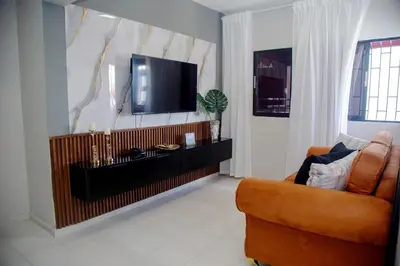 a living room with a television and a couch at Luxury Apartment in Santiago de los Caballeros