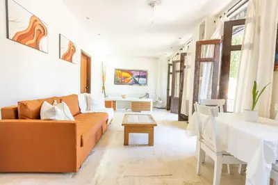 a living room with a couch and a table at Casa De Mabel in Santo Domingo