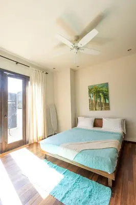 a bedroom with a bed and a ceiling fan at Casa De Mabel in Santo Domingo