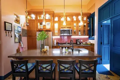 a kitchen with a large wooden table and chairs at Stylish Colonial Townhouse in Santo Domingo's Historic Heart in Santo Domingo