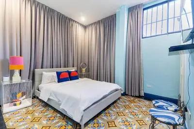 a bedroom with a bed and a large window at Stylish Colonial Townhouse in Santo Domingo's Historic Heart in Santo Domingo
