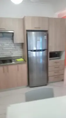 a kitchen with a stainless steel refrigerator and cabinets at Cozy apartment in Boca Chica in Boca Chica