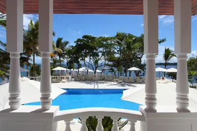a view of the pool from the porch of a resort at Bahia Principe Grand Samana - Adults Only in Santa Bárbara de Samaná