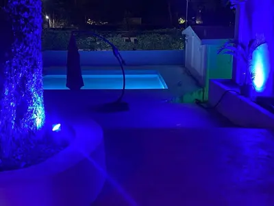 a dark room with a pool with purple lights at Hannabi Hotel in Boca Chica