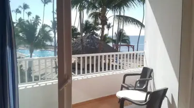 a balcony with two chairs and a view of the ocean at Appartamento Albatros, Juan Dolio in Juan Dolio