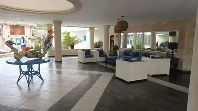 a lobby with a couch and chairs and a table at Appartamento Albatros, Juan Dolio in Juan Dolio