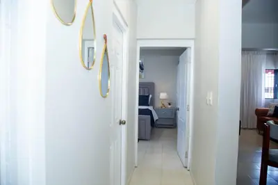 a hallway leading to a room with a bedroom at Luxury 2 bedroom Apartment in Santiago de los Caballeros