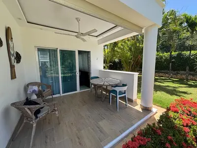 a patio with a table and chairs on it at Apartment en residence face à la Mer in Las Terrenas
