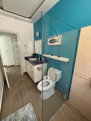 a bathroom with a toilet and a sink at Apartment en residence face à la Mer in Las Terrenas