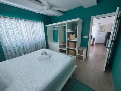 a bedroom with a bed with a towel on it at Apartment en residence face à la Mer in Las Terrenas