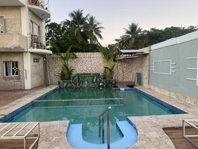 a swimming pool in front of a building at Villa Hotel Saul & Lucas in Castillo