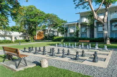 a large chess board in front of a building at Emotions by Hodelpa - Juan Dolio in Juan Dolio
