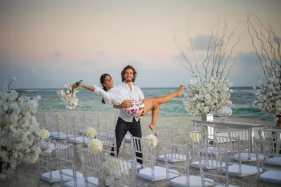 a man and a woman standing in front of a beach at Emotions by Hodelpa - Juan Dolio in Juan Dolio