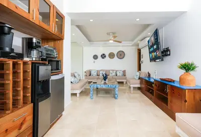 a kitchen and living room with a couch and a table at Upper-Level Penthouse, Beachfront Residence in Las Terrenas