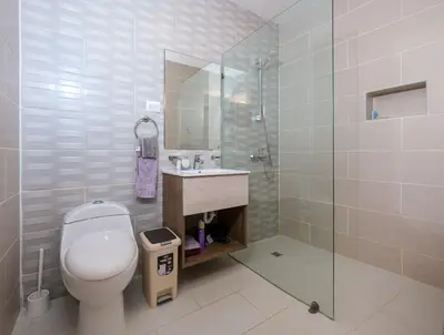 a bathroom with a toilet and a sink and a shower at Upper-Level Penthouse, Beachfront Residence in Las Terrenas