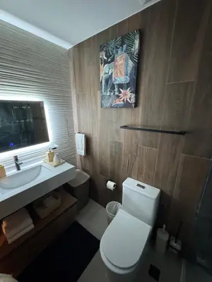 a bathroom with a white toilet and a sink at Private Lux Oasis, Vista Cana, Punta Cana in Punta Cana