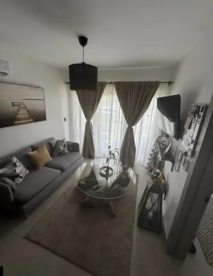 a living room with a couch and a glass table at Private Lux Oasis, Vista Cana, Punta Cana in Punta Cana