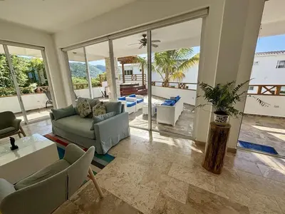 a living room with a couch and a table at Beautiful apartment with sea view in Las Terrenas