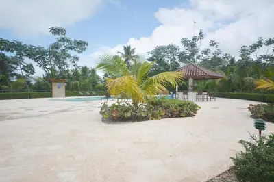 a courtyard with a pool and a gazebo at Beautiful apartment with sea view in Las Terrenas