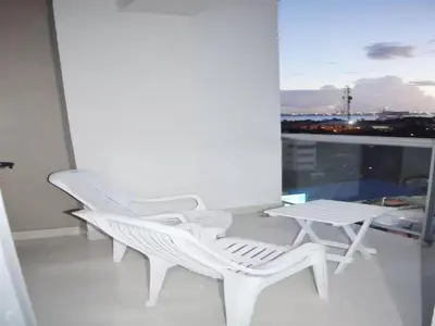 two white chairs and a table on a balcony at Relaxing Ocean View Getaway in Boca Chica501 in Boca Chica