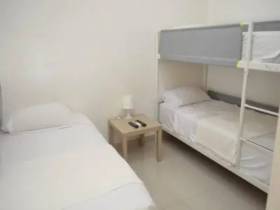 a bedroom with two bunk beds and a table at Relaxing Ocean View Getaway in Boca Chica501 in Boca Chica