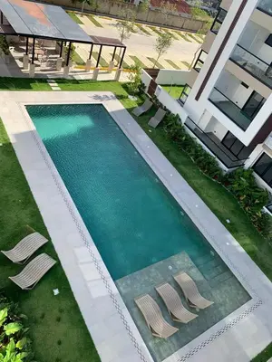 an overhead view of a swimming pool with two chairs at Prado Suites Luxurious Apartment for Long Term Stay in Las Terrenas