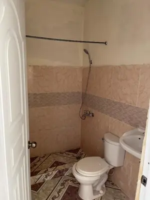 a bathroom with a toilet and a sink at Alexel Property
