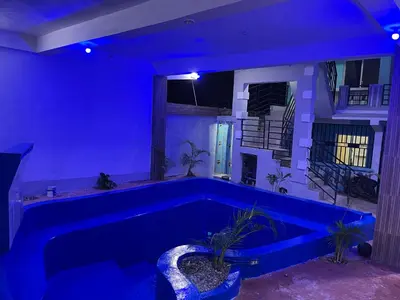 a blue room with a tub with plants in it at Alexel Property