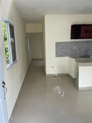 an empty room with a kitchen and a sink at Alexel Property