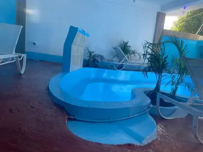 a blue room with a tub with a plant in it at Alexel Property