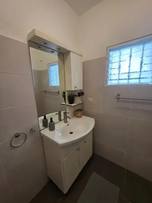 a bathroom with a sink and a mirror at Serenity Dominicus in La Laguna