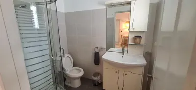 a bathroom with a toilet and a sink and a mirror at Serenity Dominicus in La Laguna