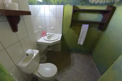 a small bathroom with a toilet and a sink at Hotel El Rancho Sosua in Sosúa