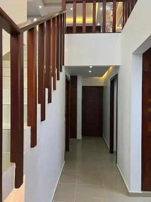 a hallway with white walls and wooden staircases at Residencial Pancho III in Los Mameyes