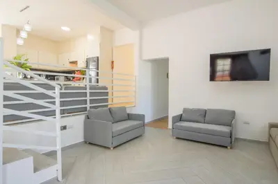 a living room with two chairs and a staircase at VILLA LEMON Samaná in El Limón