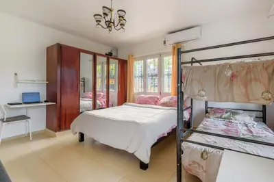 a bedroom with two bunk beds and a desk at VILLA LEMON Samaná in El Limón