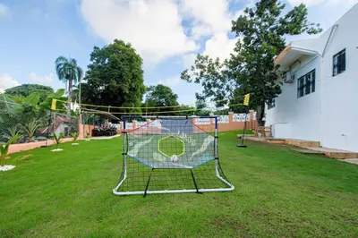 a net with a soccer ball on it in a yard at VILLA LEMON Samaná in El Limón