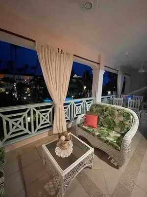 a living room with a couch and a table at Waterfront apartment in Las Terrenas